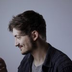 A man with an electronic device.