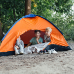 Kids in a tent on a camping trip.