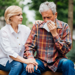 A person sick on a camping trip.